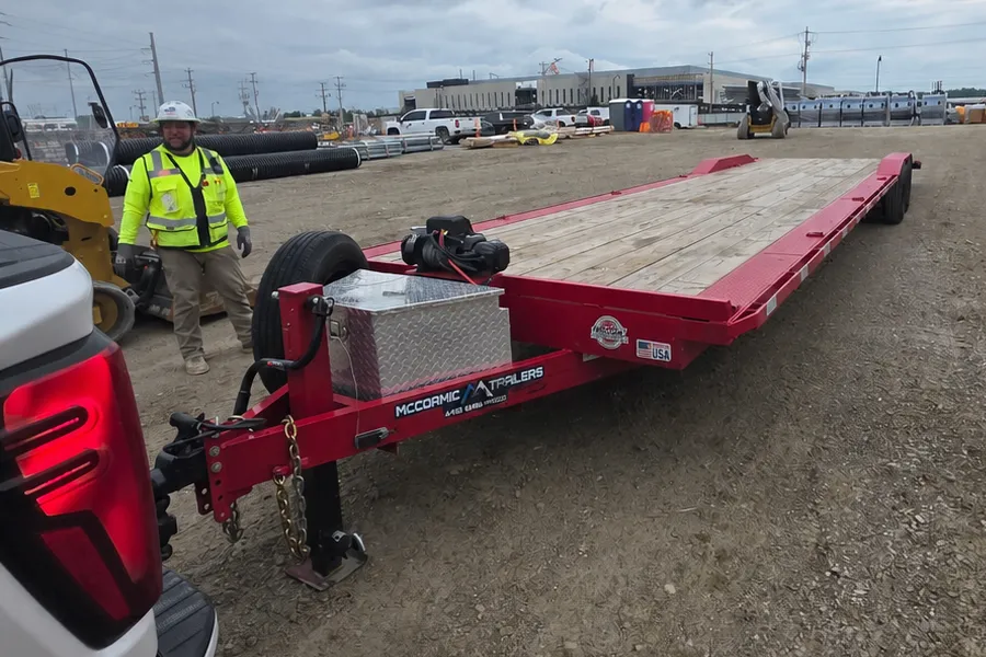 A flatbed equipment trailer delivered to a construction jobsite.
